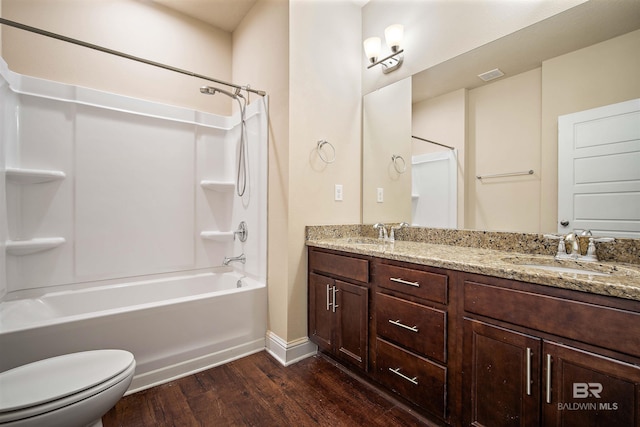 full bathroom featuring wood-type flooring, vanity, toilet, and washtub / shower combination