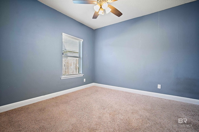 carpeted spare room with ceiling fan