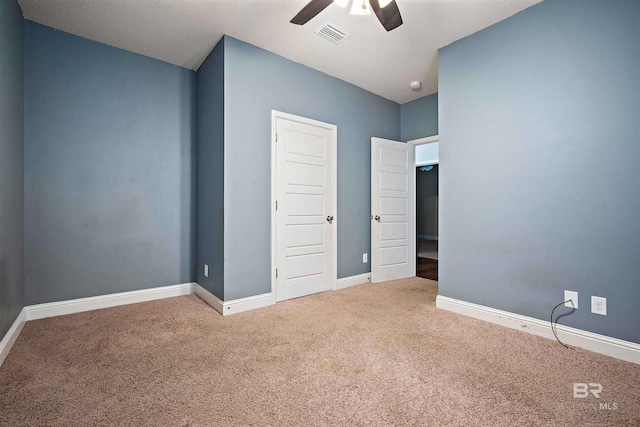 unfurnished bedroom featuring carpet floors and ceiling fan