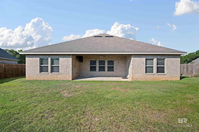 rear view of property with a patio and a yard