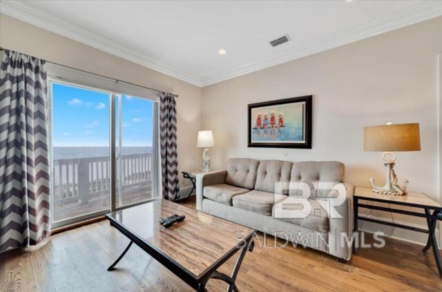 2223 W Beach Blvd, Gulf Shores, AL 36542 - living area with visible vents, ornamental molding, and wood finished floors