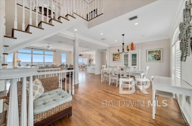 2223 W Beach Blvd, Gulf Shores, AL 36542 - interior space featuring wood finished floors, plenty of natural light, crown molding, and visible vents