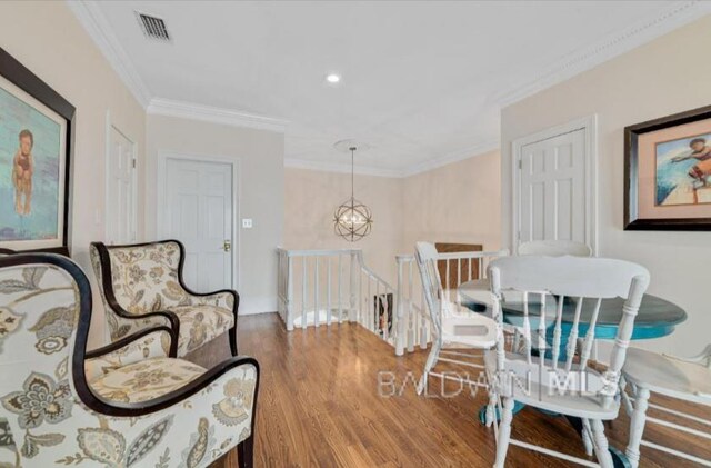 2223 W Beach Blvd, Gulf Shores, AL 36542 - dining area featuring wood finished floors, ornamental molding, a chandelier, and visible vents