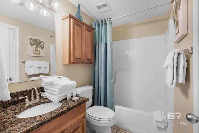 full bathroom featuring tile patterned floors, vanity, a textured ceiling, shower / tub combo with curtain, and toilet