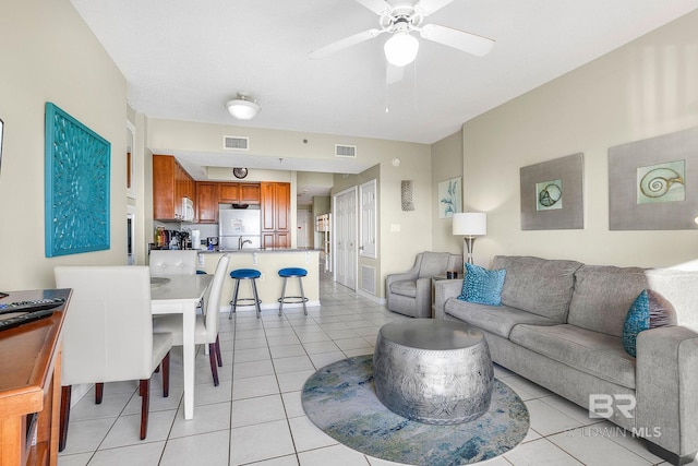 tiled living room featuring ceiling fan