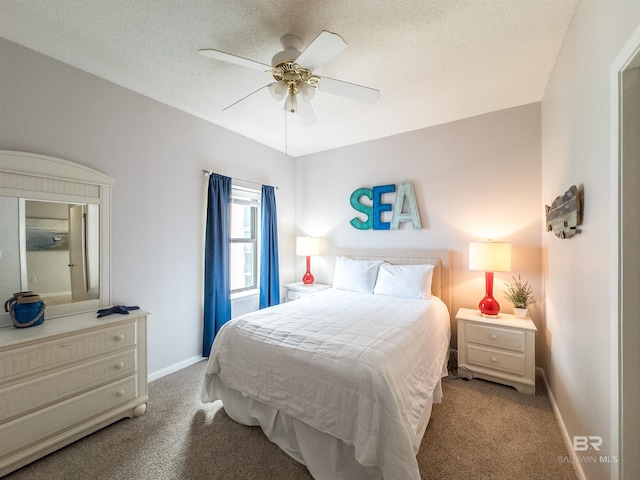 bedroom with ceiling fan, light colored carpet, and a textured ceiling