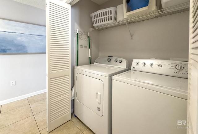 laundry room featuring light tile patterned floors and washing machine and dryer