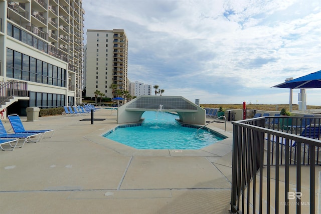 view of swimming pool with a patio and pool water feature