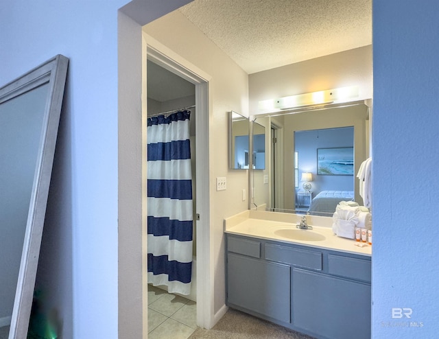 bathroom featuring tile patterned floors, vanity, a textured ceiling, and a shower with shower curtain