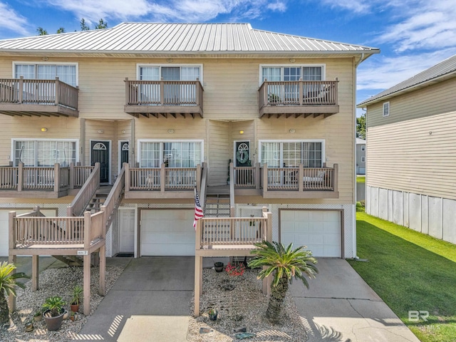 4 Yacht Club Dr Unit 15, Daphne, AL 36526 - view of front of house with concrete driveway, an attached garage, and metal roof