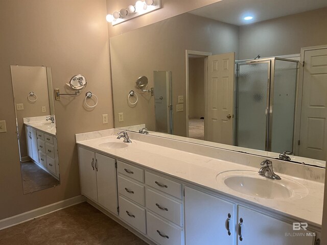 full bathroom with a shower stall and double vanity