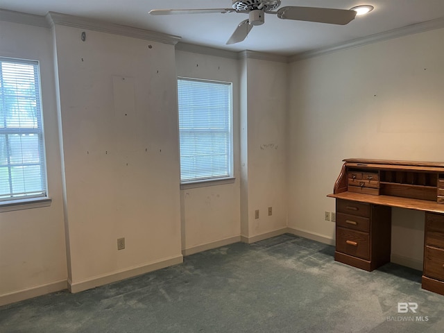 unfurnished office featuring carpet flooring, healthy amount of natural light, a ceiling fan, crown molding, and baseboards