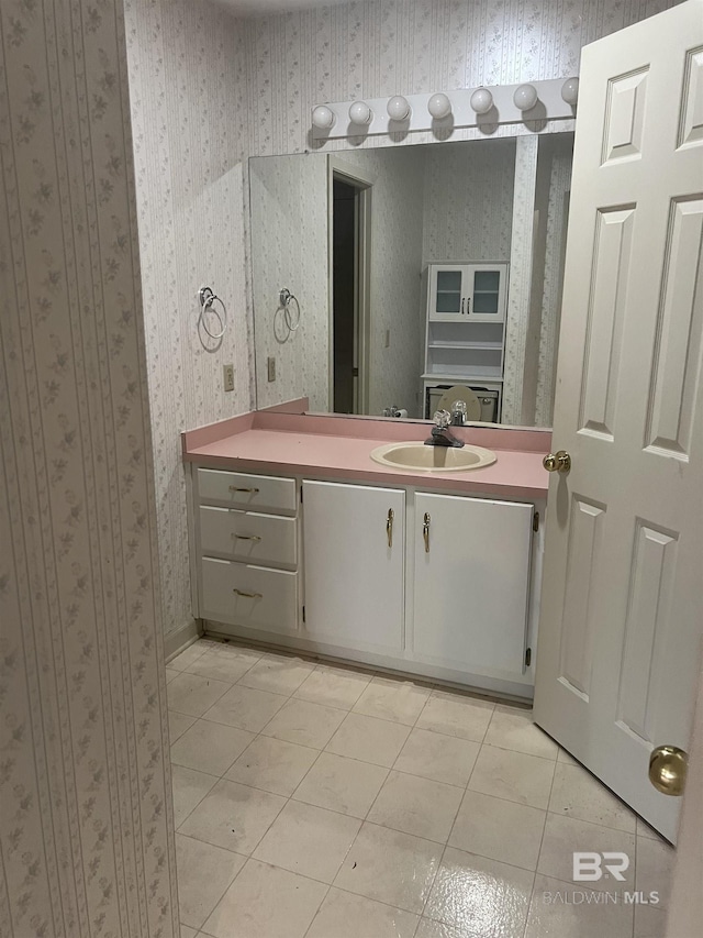 bathroom with wallpapered walls, vanity, and tile patterned floors