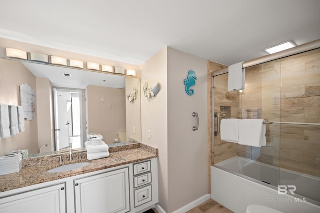 full bath featuring enclosed tub / shower combo, vanity, and baseboards