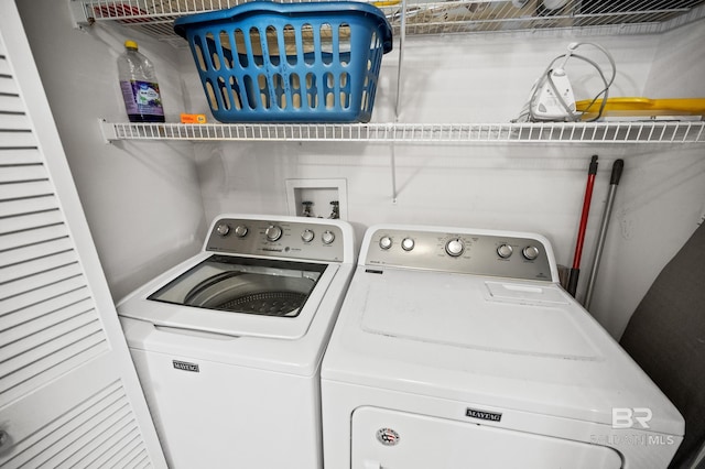 clothes washing area featuring laundry area and washing machine and clothes dryer