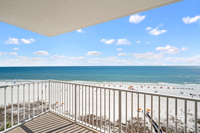 balcony featuring a beach view and a water view