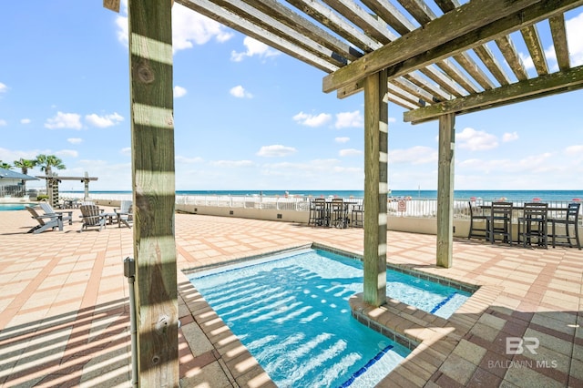 view of swimming pool with a patio area, a water view, and a pergola