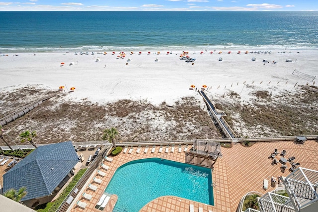 aerial view with a water view and a beach view