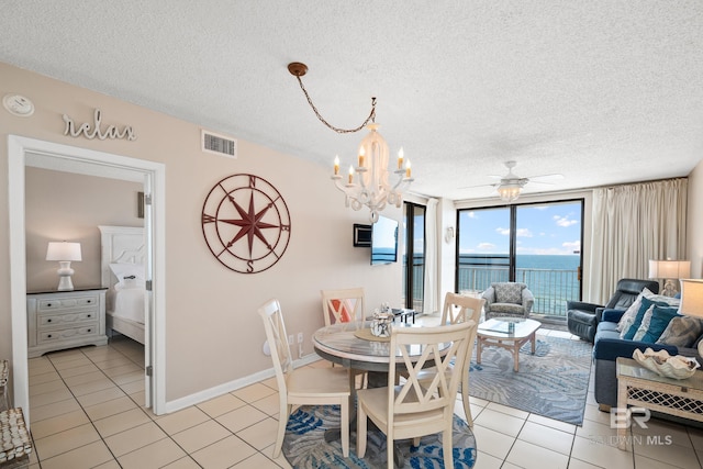 dining area featuring visible vents, a textured ceiling, baseboards, and light tile patterned floors