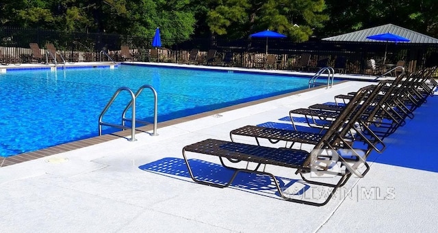 119 Sandlewood Cir, Daphne, AL 36526 - community pool featuring a patio and view of wooded area