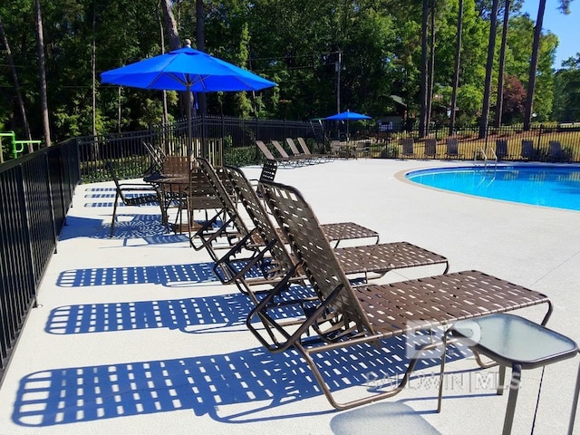 119 Sandlewood Cir, Daphne, AL 36526 - community pool featuring a patio and view of wooded area