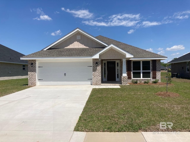 view of front of property with a garage, a front yard, and brick siding