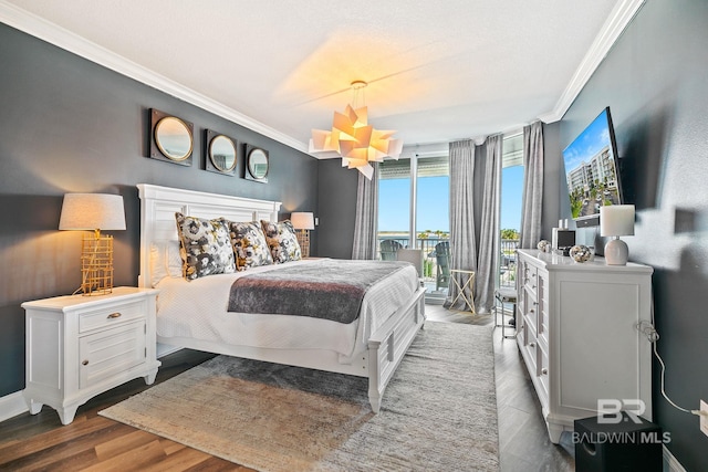 bedroom featuring dark wood-type flooring, access to exterior, and ornamental molding