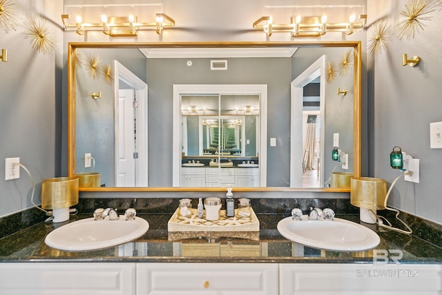 bathroom featuring ornamental molding and vanity