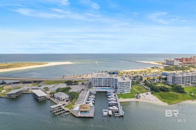 bird's eye view with a water view and a beach view