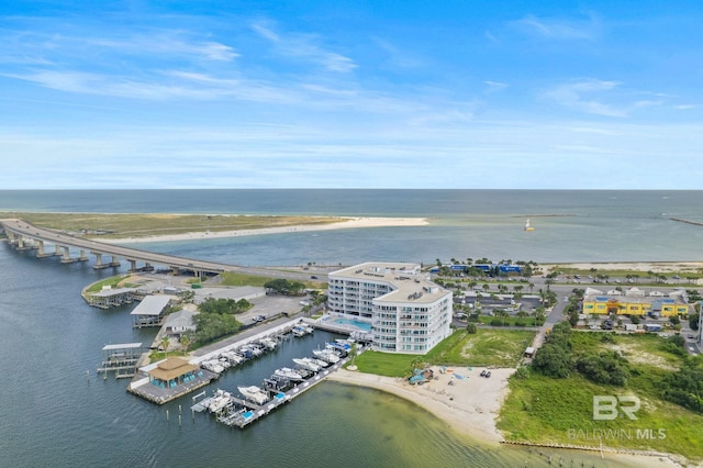 drone / aerial view featuring a water view and a view of the beach