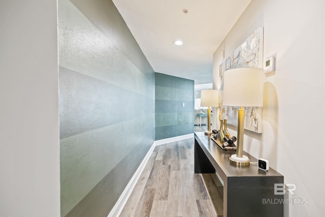 hallway with hardwood / wood-style floors