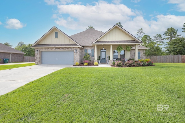 craftsman inspired home featuring a garage and a front lawn