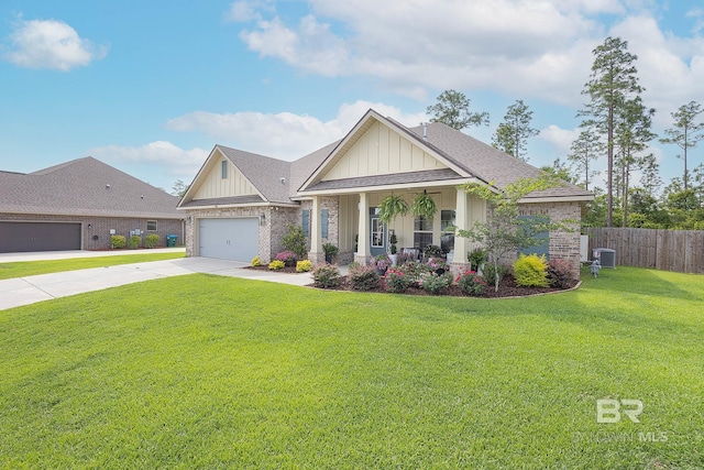 craftsman-style house featuring a garage, a front yard, and central air condition unit