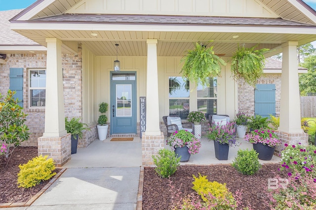 view of exterior entry with a porch