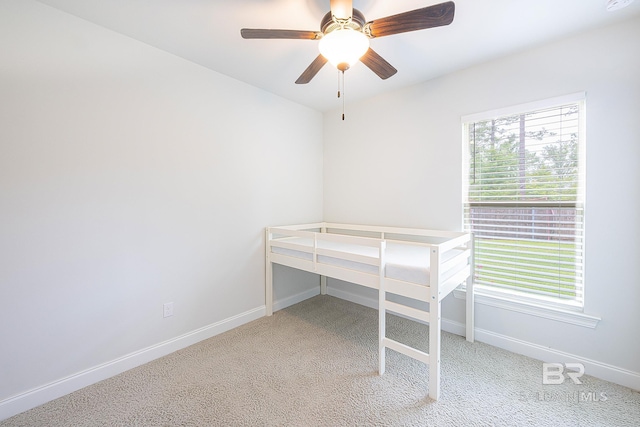 unfurnished bedroom with light carpet and ceiling fan