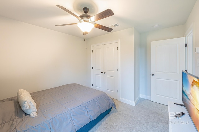 carpeted bedroom with a closet and ceiling fan