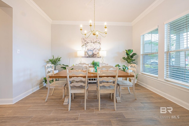 dining area featuring a notable chandelier, hardwood / wood-style floors, and crown molding