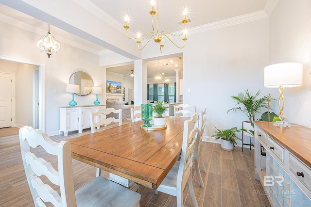 dining area featuring an inviting chandelier, hardwood / wood-style flooring, and crown molding