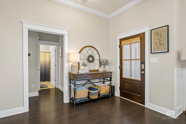 foyer entrance featuring crown molding, baseboards, and wood finished floors