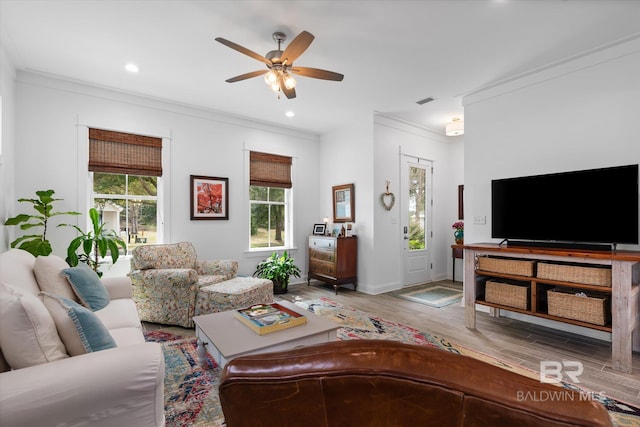 living room with baseboards, ceiling fan, ornamental molding, wood finished floors, and recessed lighting