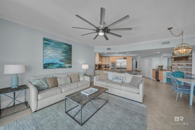 living area with light tile patterned floors, visible vents, a textured ceiling, and ornamental molding