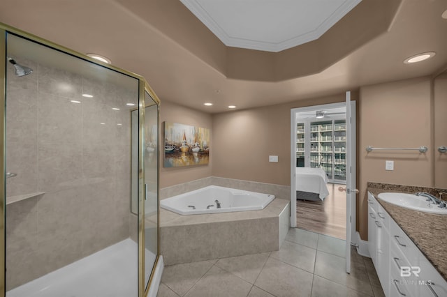 ensuite bathroom with tile patterned flooring, a tub with jets, a shower stall, and vanity