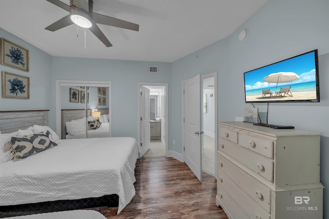 bedroom featuring a ceiling fan, wood finished floors, visible vents, a closet, and connected bathroom