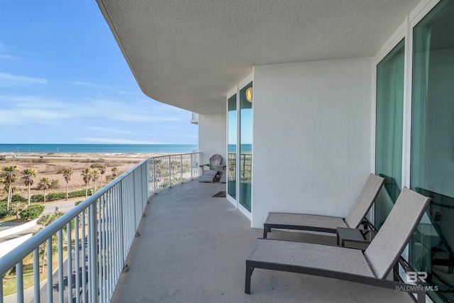 balcony with a view of the beach and a water view