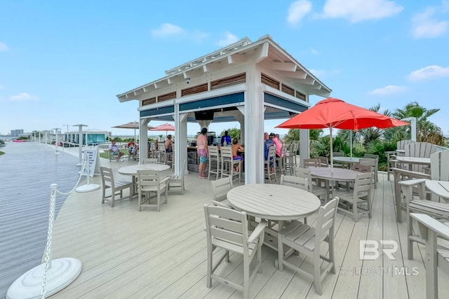 wooden terrace featuring outdoor dining area