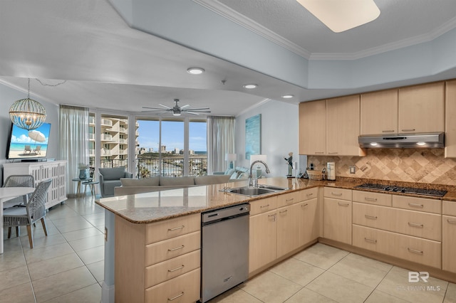 kitchen featuring under cabinet range hood, black stovetop, light brown cabinetry, and a sink