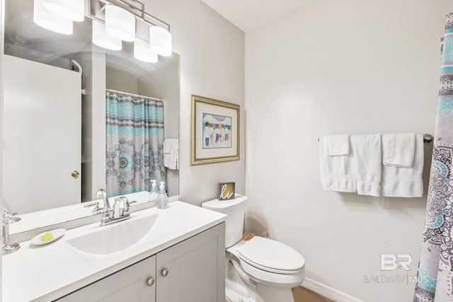 full bathroom with toilet and vanity