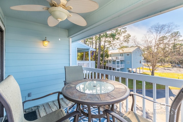 balcony featuring outdoor dining area and a ceiling fan