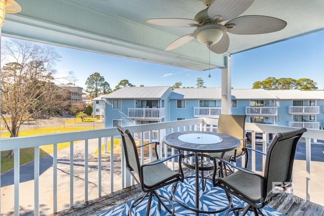 wooden deck featuring a residential view and a ceiling fan