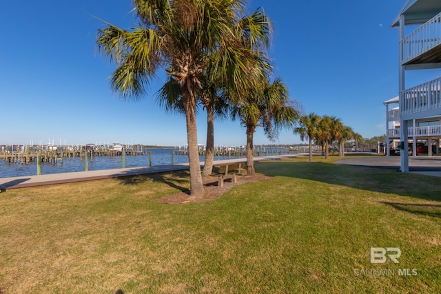 view of yard featuring a boat dock and a water view